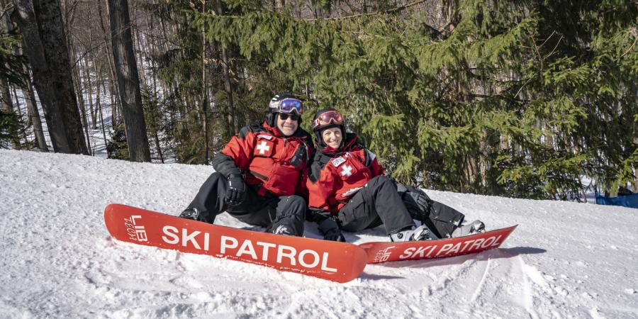 ski patrol sitting on the mountain