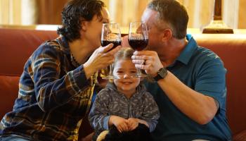 2 parents drinking wine