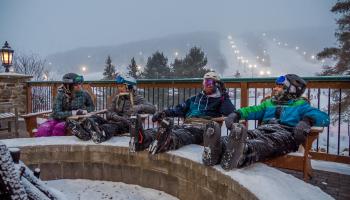 4 skiers relaxing on the mountain