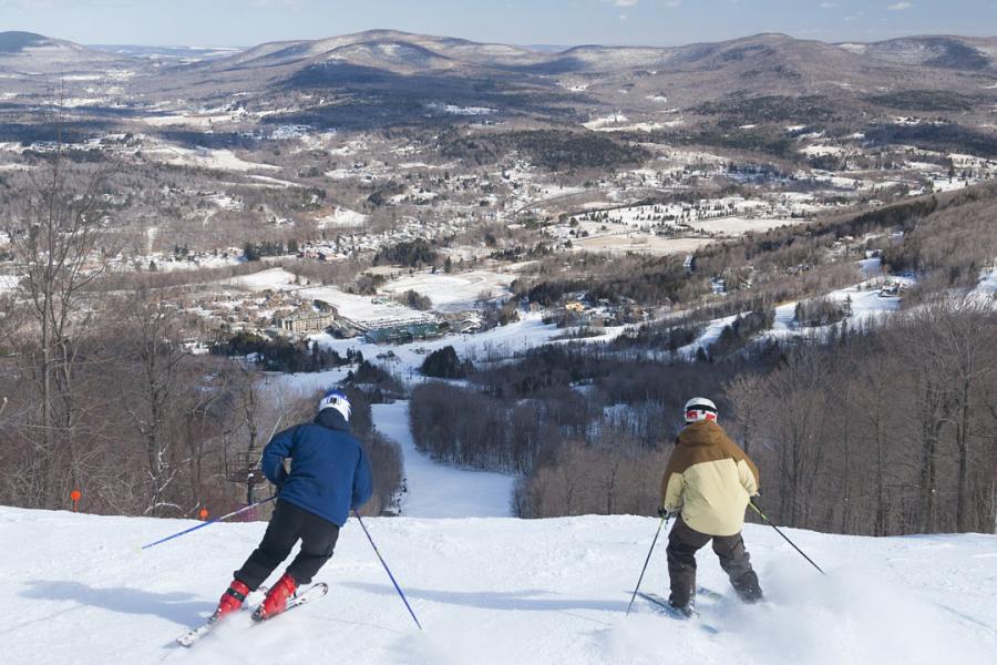 2 people skiing downhill